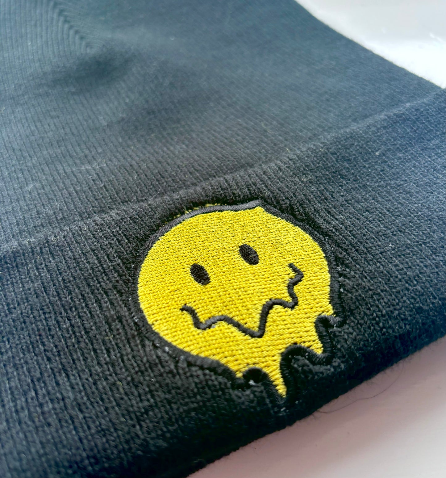 Melting Smiley Face Embroidered Cuffed Beanie Hat